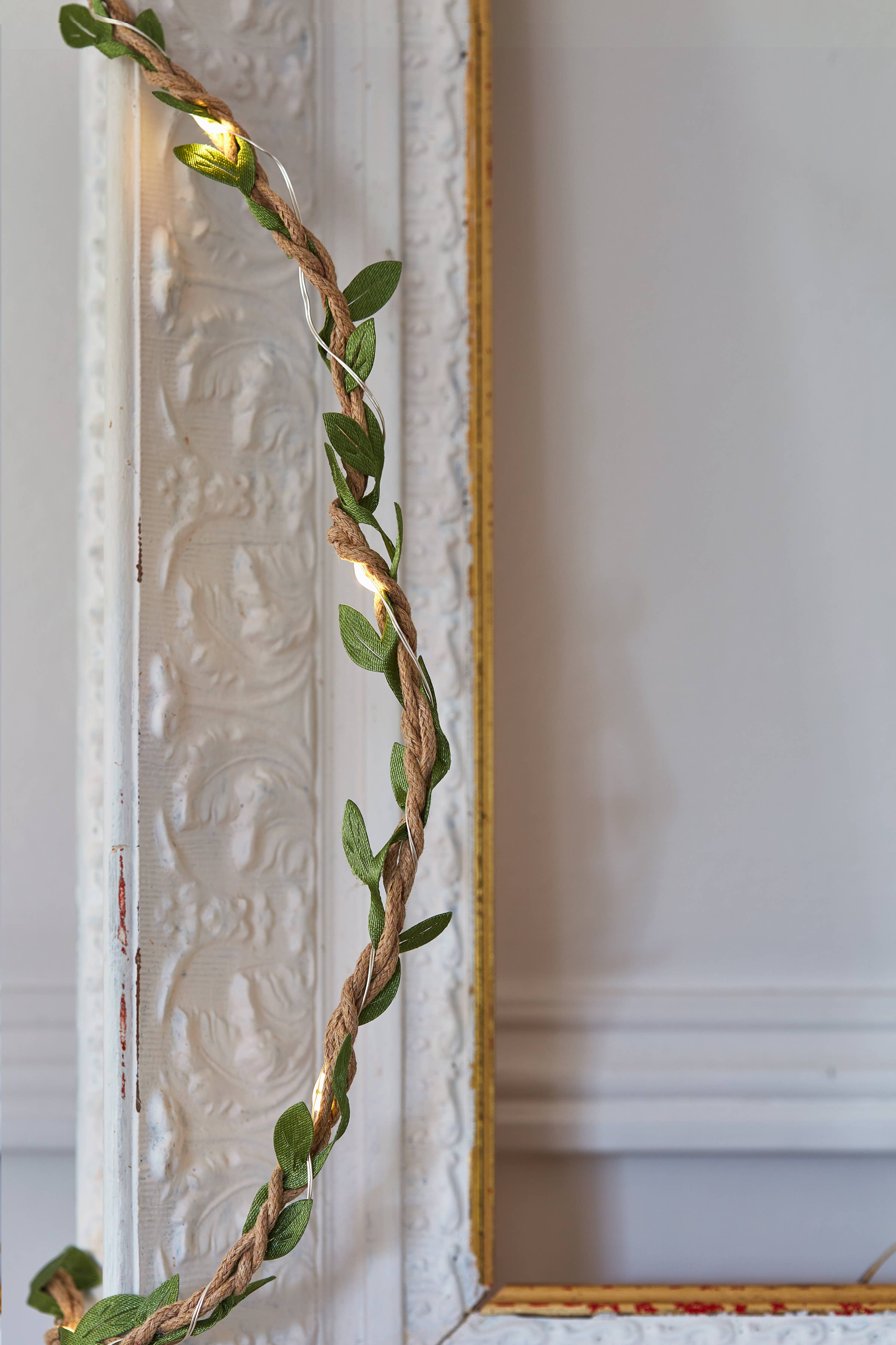 Green leafy garland with warm white LED lights on twisted fiber cord