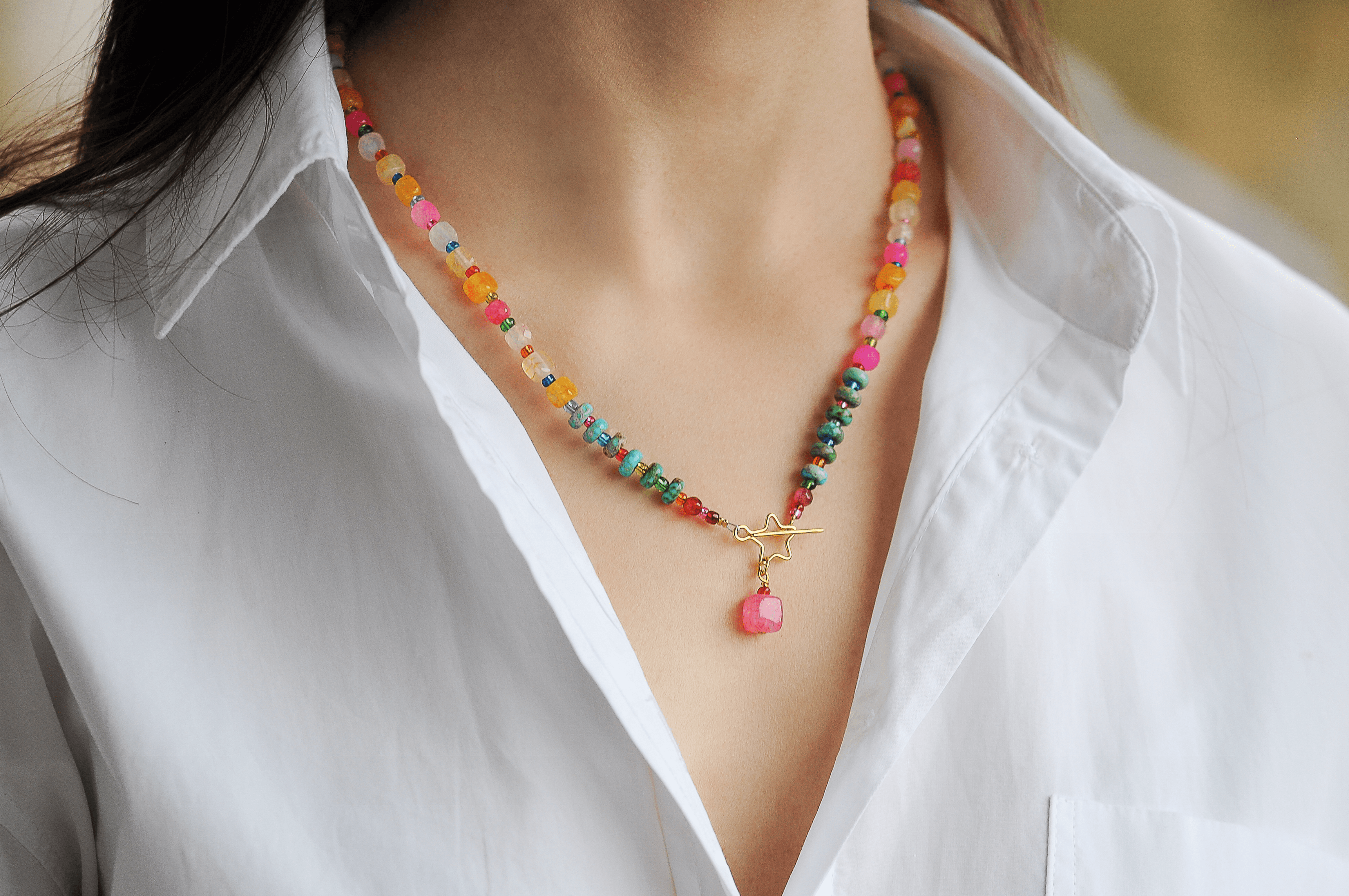 Vibrant multicolored AGM7 beaded necklace with gold star pendant and pink gem