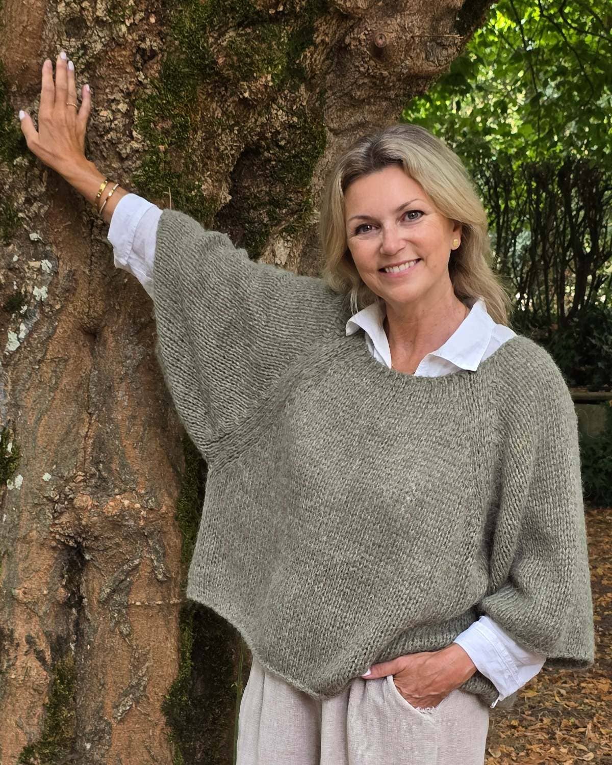 Cozy olive-green alpaca blend swing jumper in soft moss over white shirt