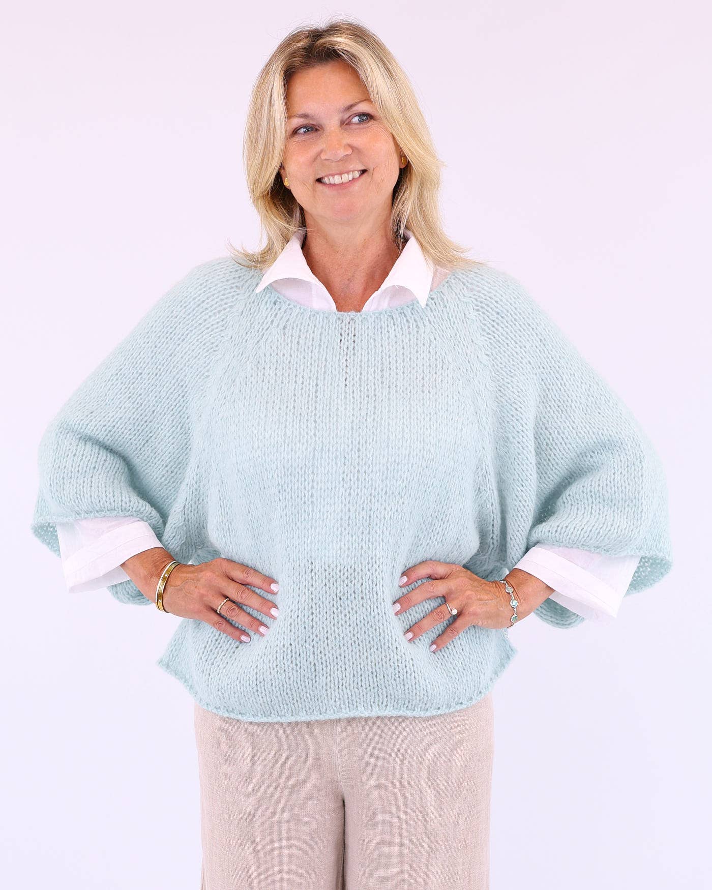 Light blue alpaca blend swing jumper poncho with white inner sleeves