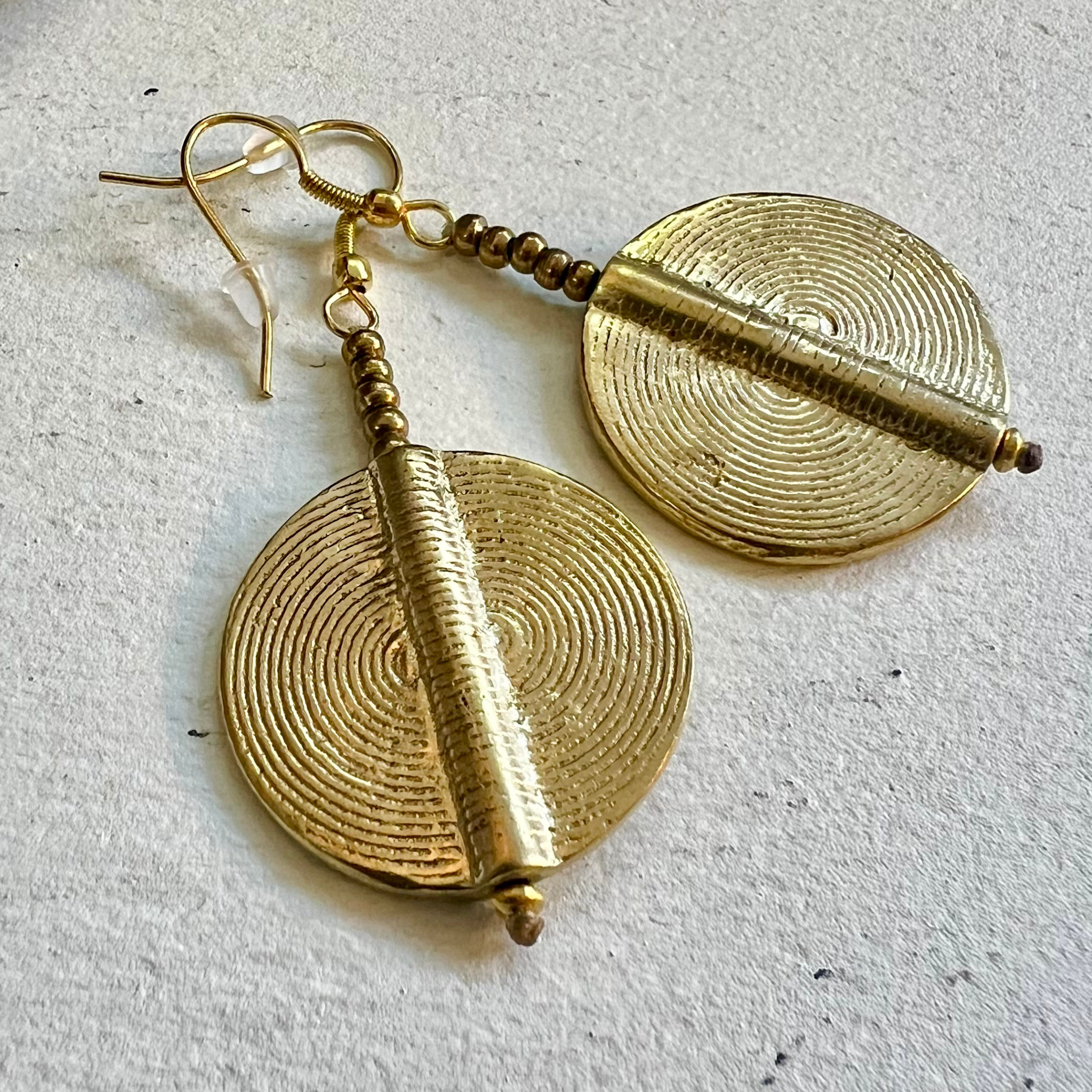 Amara Earrings: Gold circular studs with engraved patterns and beaded chains