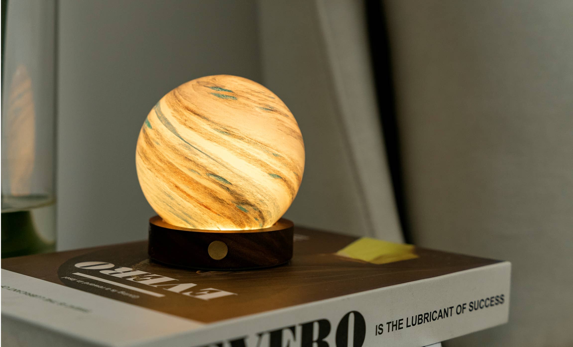 Warm-toned AstraGlass Mini Stellar Ocean lamp with glowing amber interior