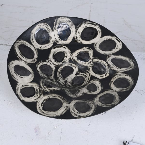 Black ceramic bowl with white brushstroke circles pattern