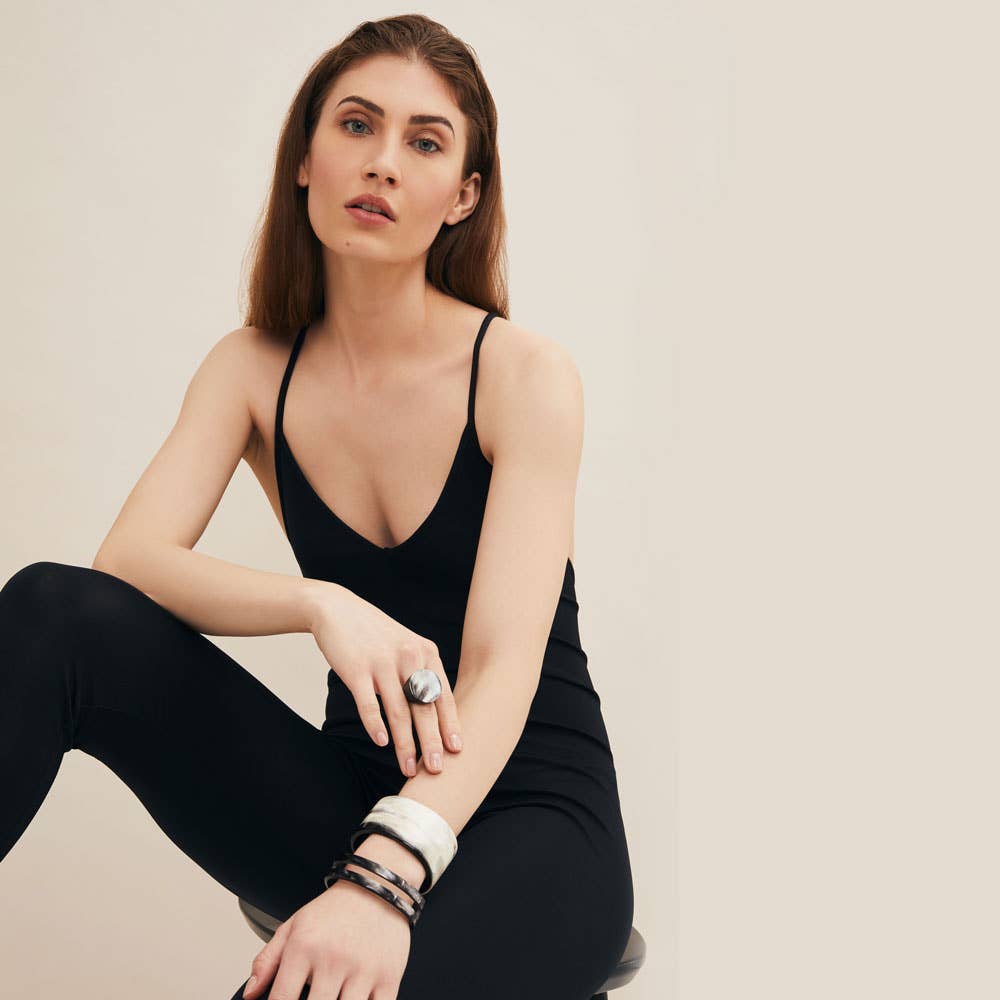 Black spaghetti strap bodysuit with deep v-neckline and buffalo horn cuff