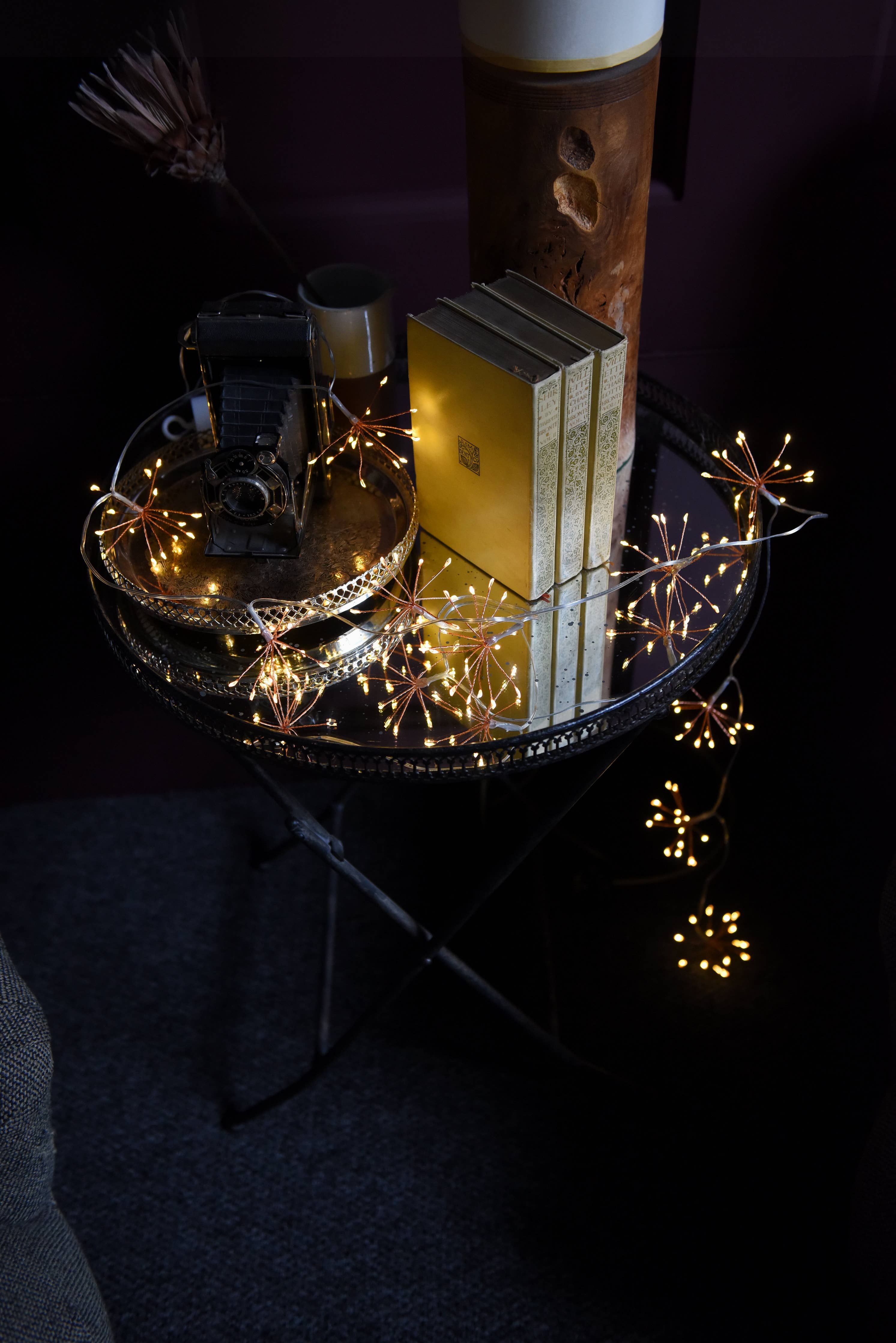 Golden starburst string lights in black battery chain