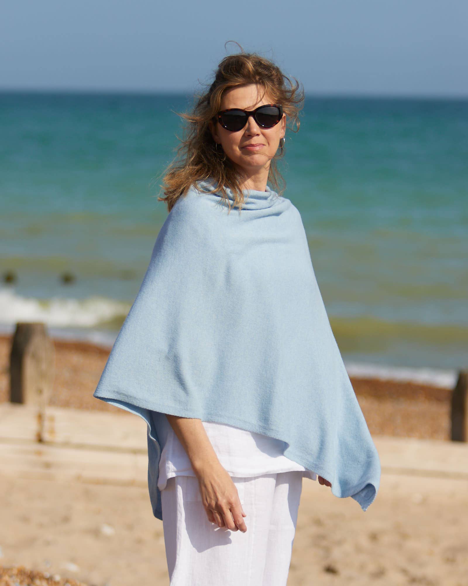 Light blue soft-textured cashmere blend poncho in lilac on woman