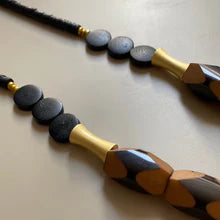 Black and gold beaded cord necklace with faceted oval wood beads