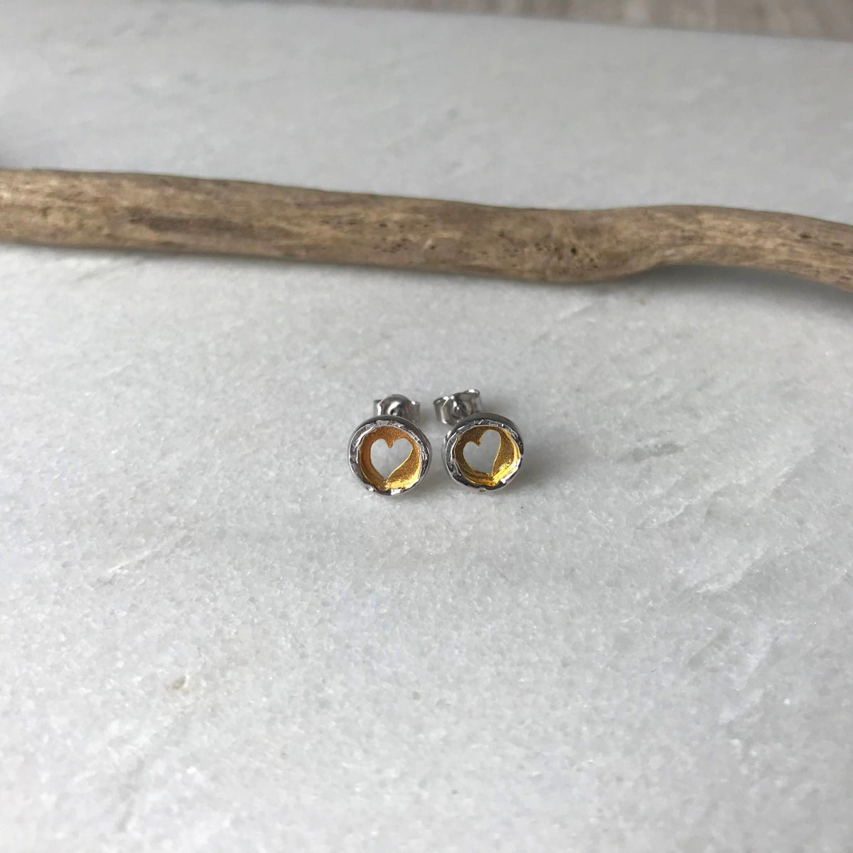 Silver stud earrings with gold-filled cut out heart design