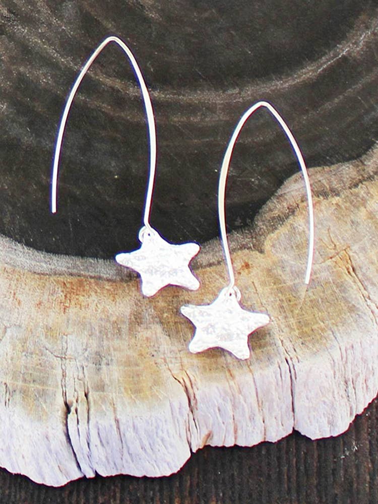 Silver star dangle earrings with hammered texture and hook backs