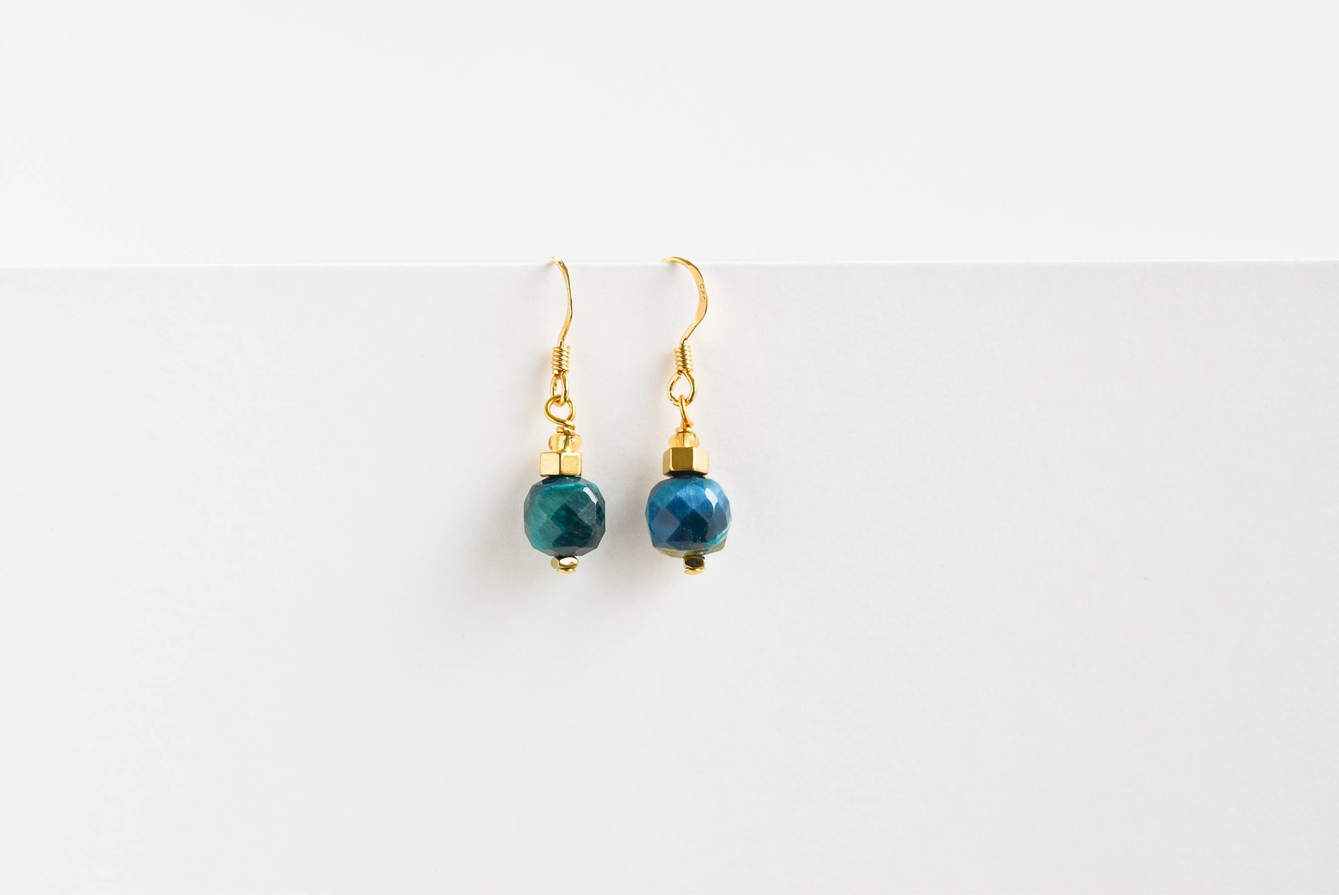 Gold-toned Eden/Ruby dangle earrings with faceted teal-blue beads