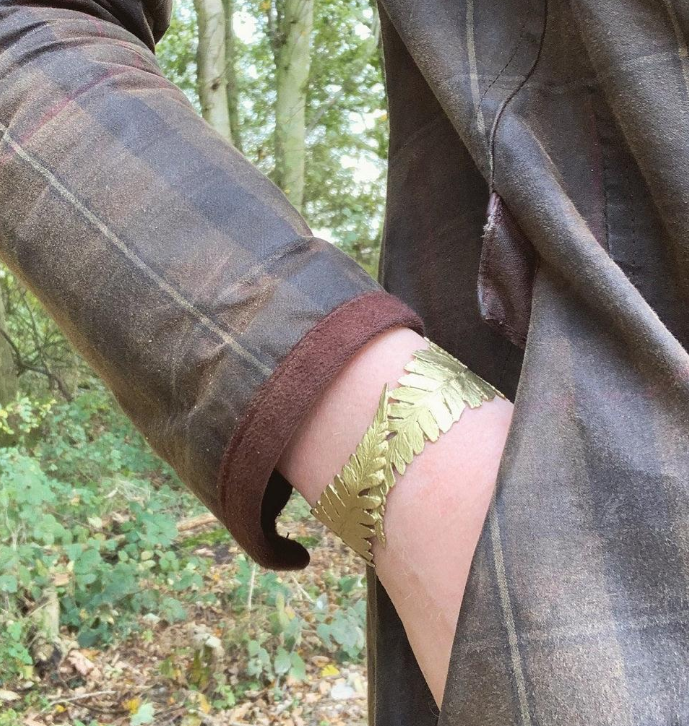 Gold-toned Fern Cuff Bracelet with leaf pattern on wrist