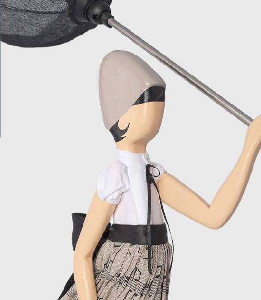 Stylized beige Georgia Lady Lamp figurine in white blouse and patterned skirt