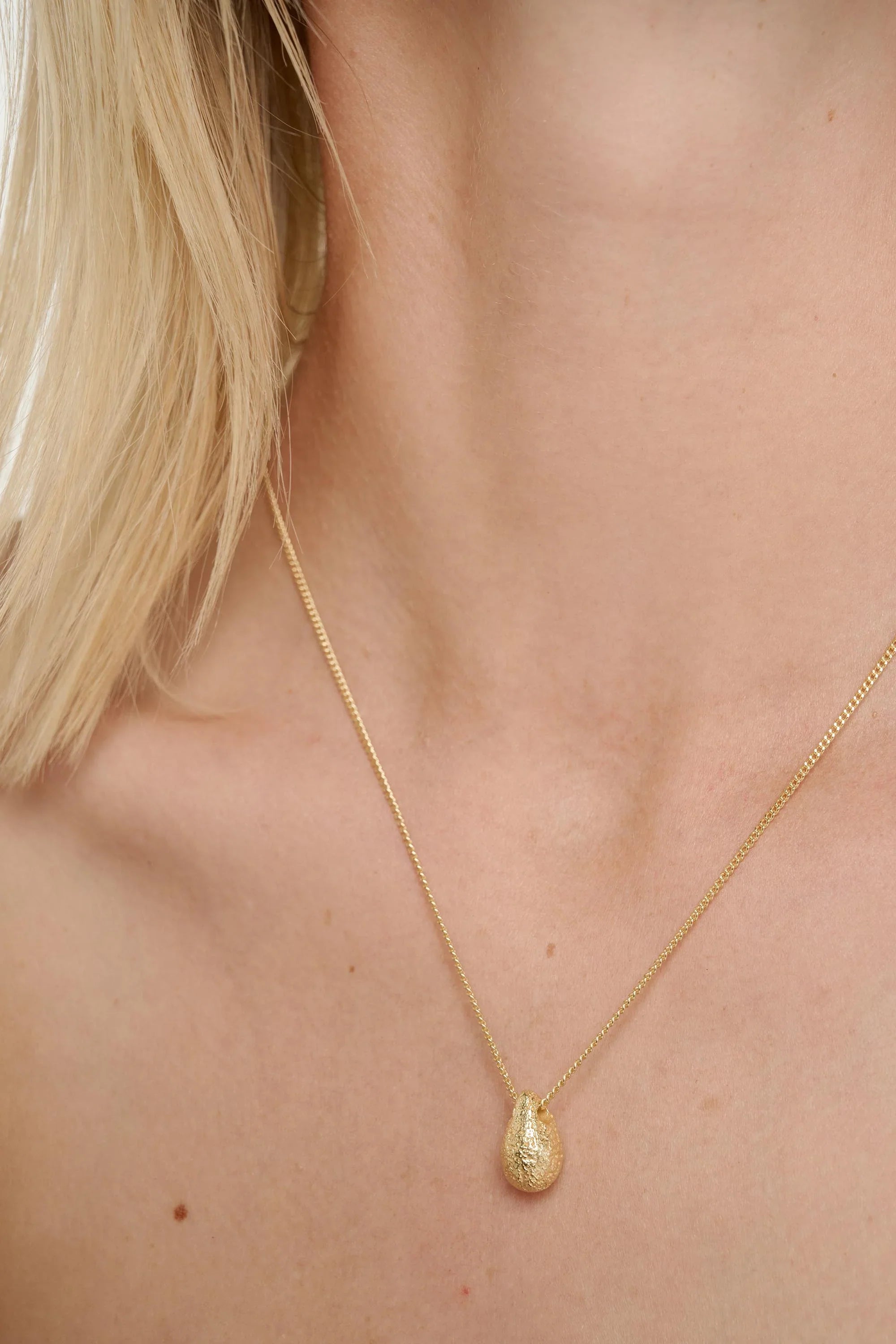 Delicate gold-toned Gold Dome Necklace with textured teardrop pendant