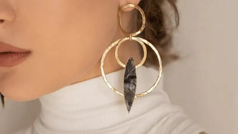Gold double circle earrings with a black stone center
