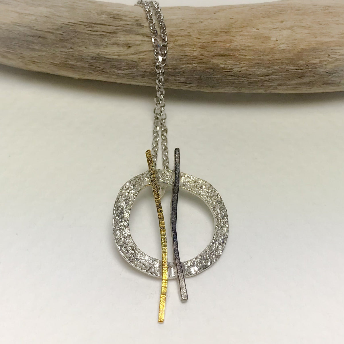Silver and gold-toned Hoop Twig pendant necklace with textured base and vertical bars