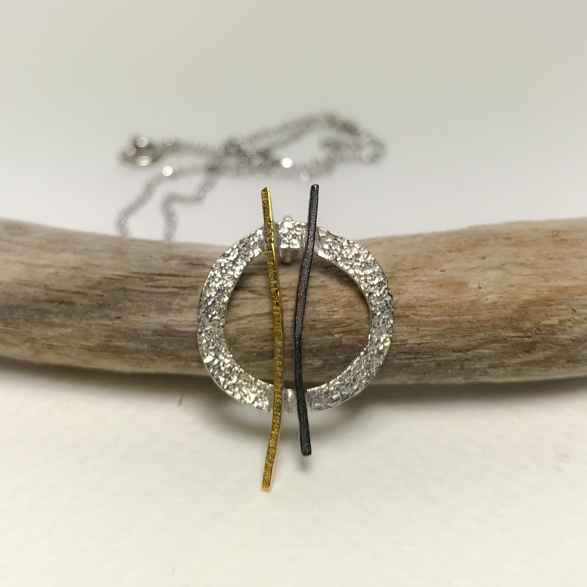 Modern abstract Hoop Twig Necklace with textured silver frame and gold black bars on branch