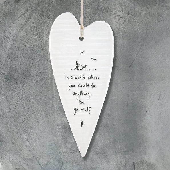 White ceramic heart wall hanging with hand-painted In A World Where inscription and black birds