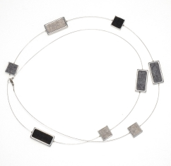 Silver-toned rectangular pendant necklace with black and gray accents