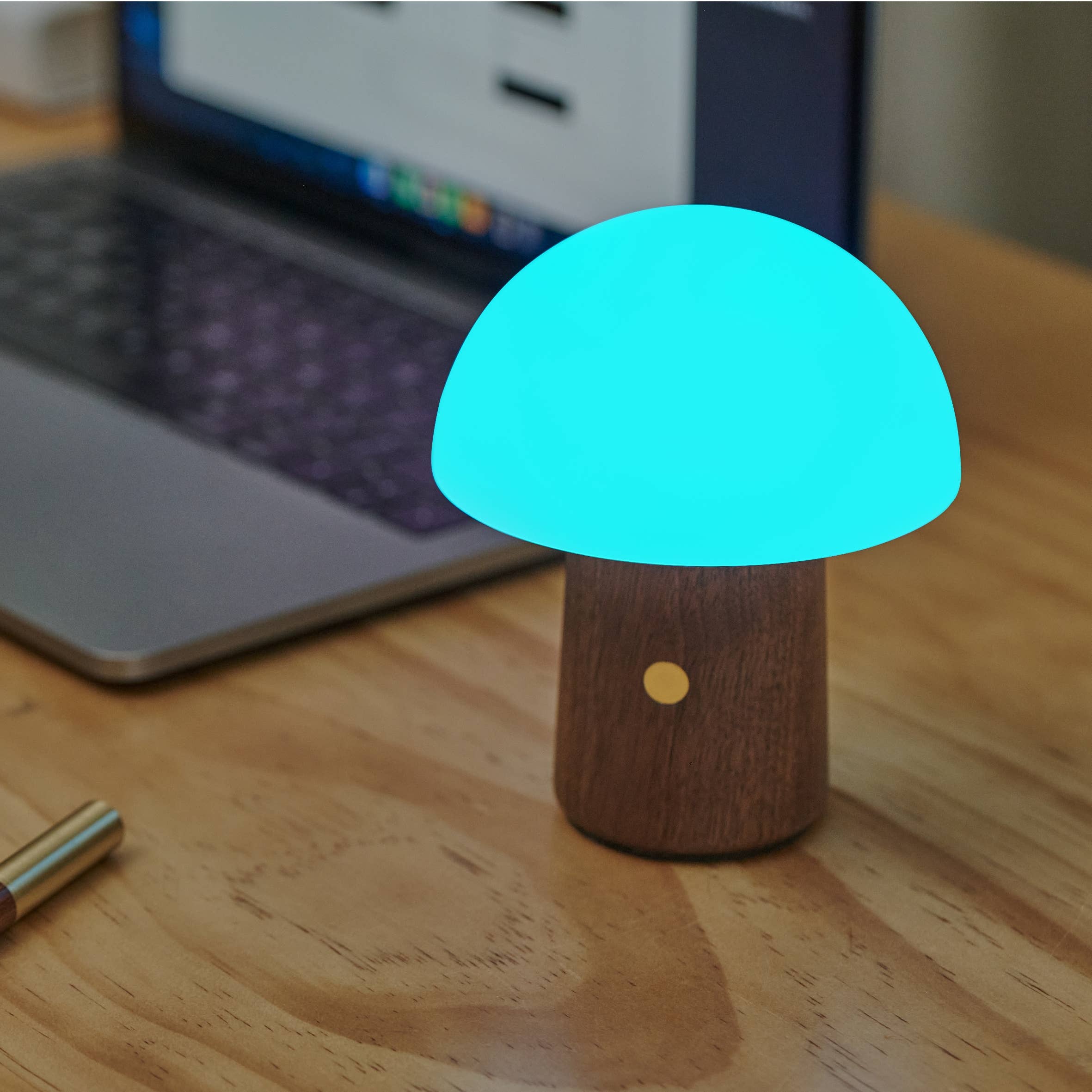 Glowing turquoise Mini Alice mushroom LED lamp on walnut base