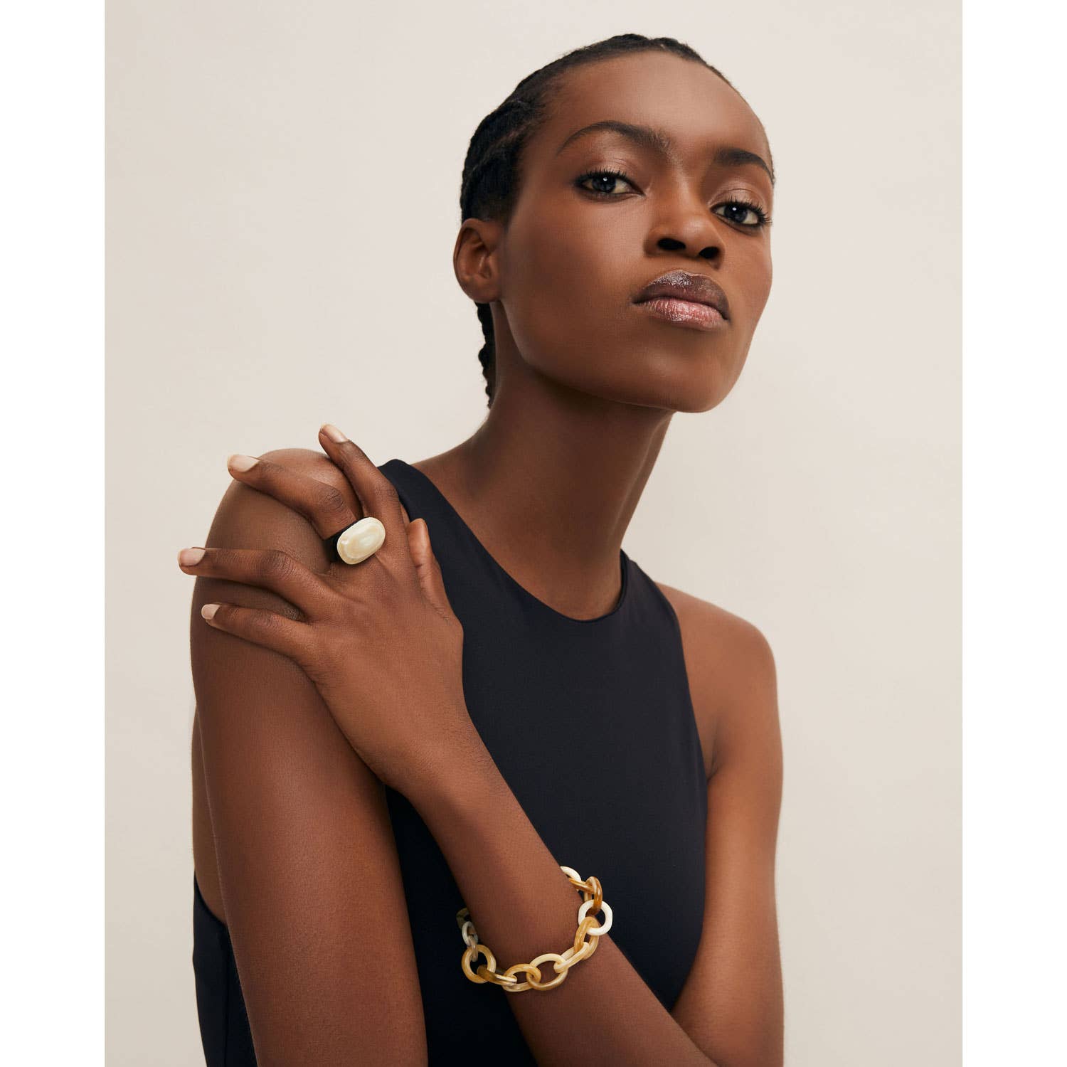 Cream-colored oval horn cocktail statement ring on finger