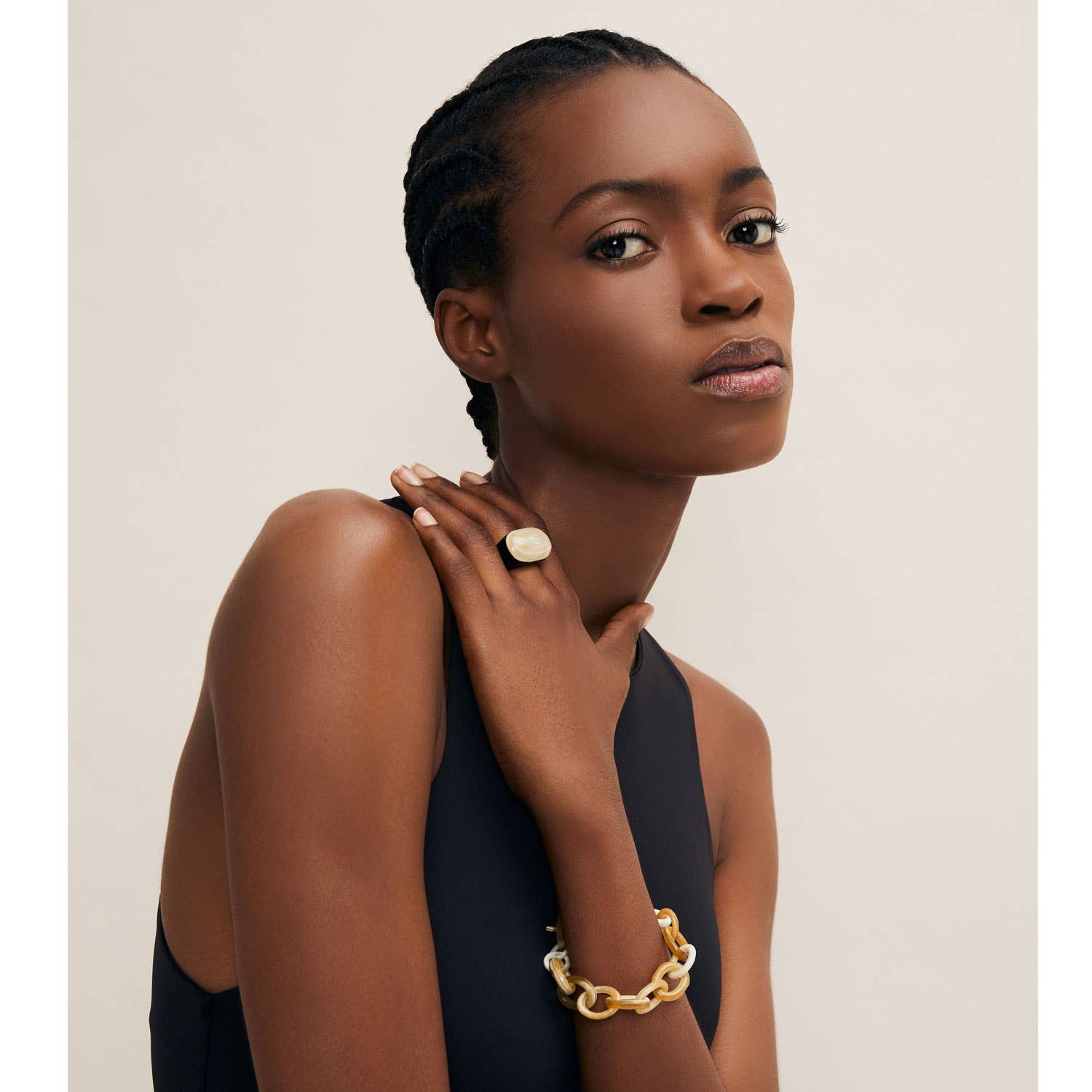 Sleek off-white oval natural horn cocktail ring on finger