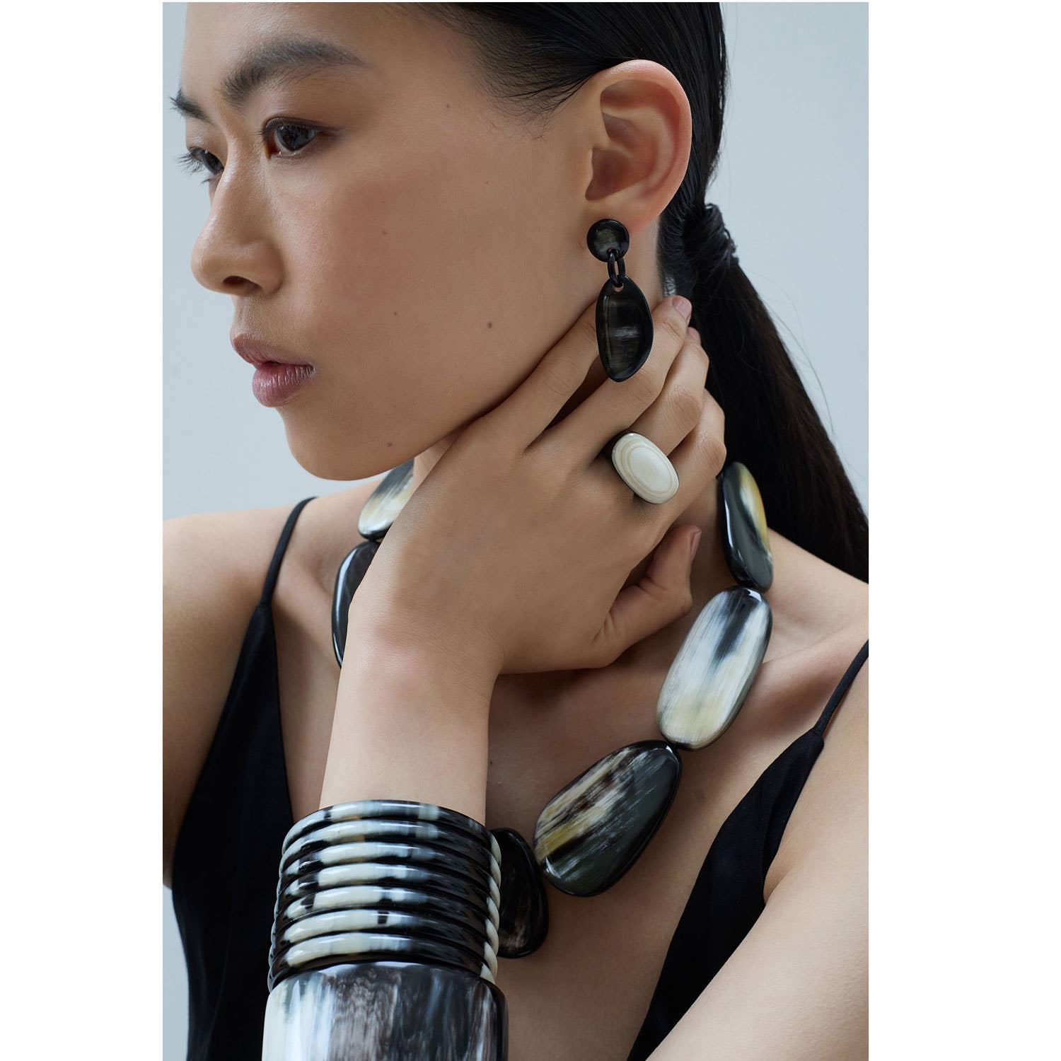 Black and white horn-like statement earrings, sleek modern oval cocktail design