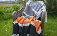 Cozy orange black striped Palette Silver Lambswool Throw on wooden chair