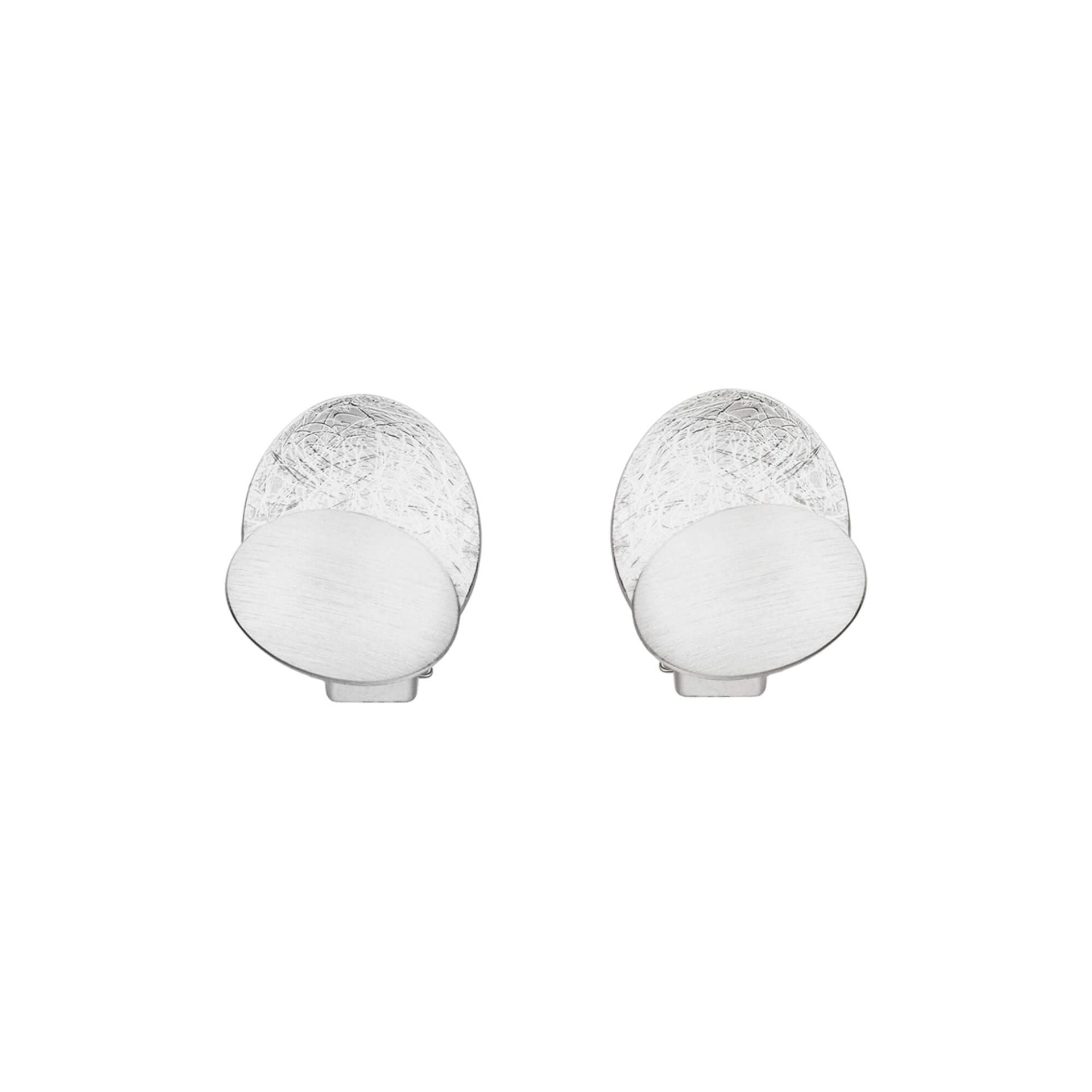 Silver textured oval clip earrings with smooth white circular accent