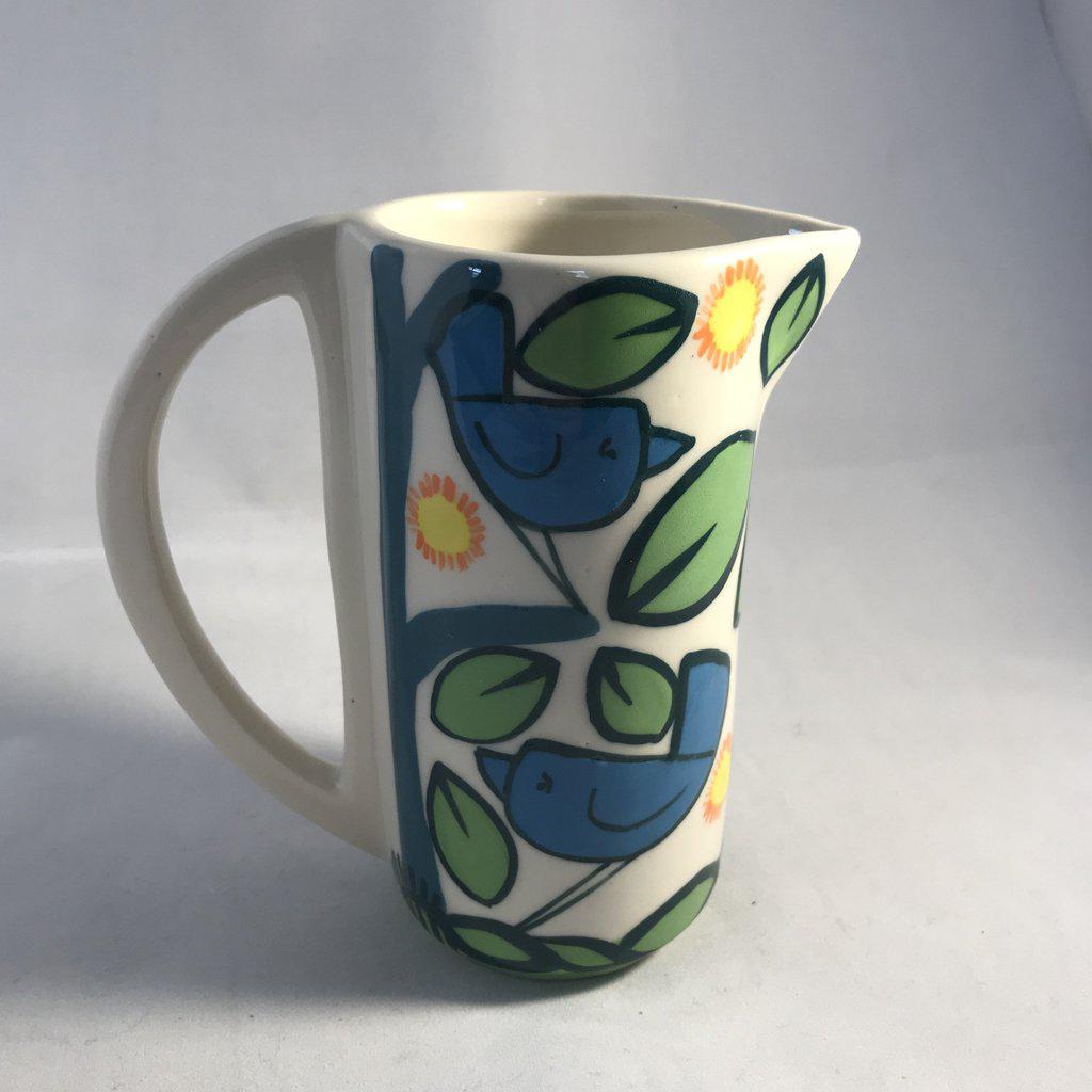 Small Birds Jug: white ceramic pitcher with blue birds, green leaves, yellow sunflowers