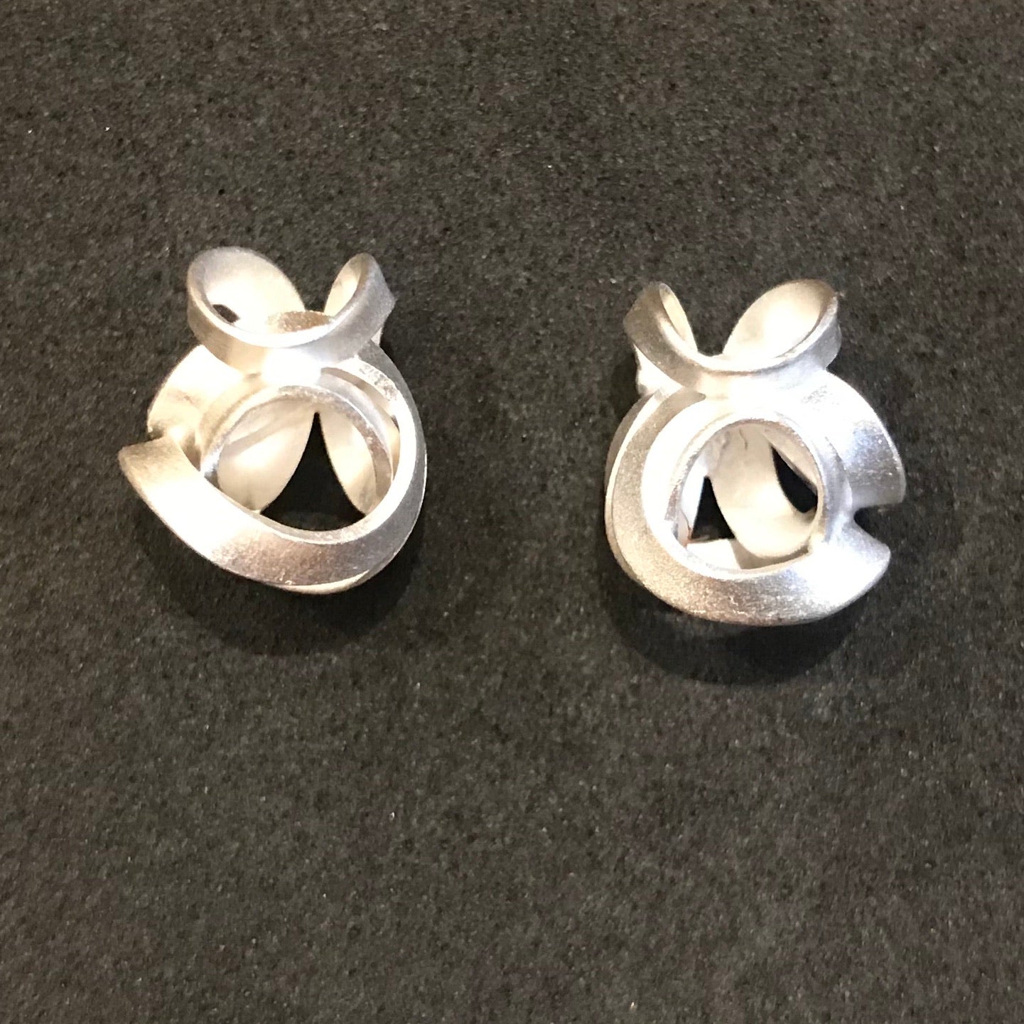 Twist Stud Earrings with silver abstract intertwined loops