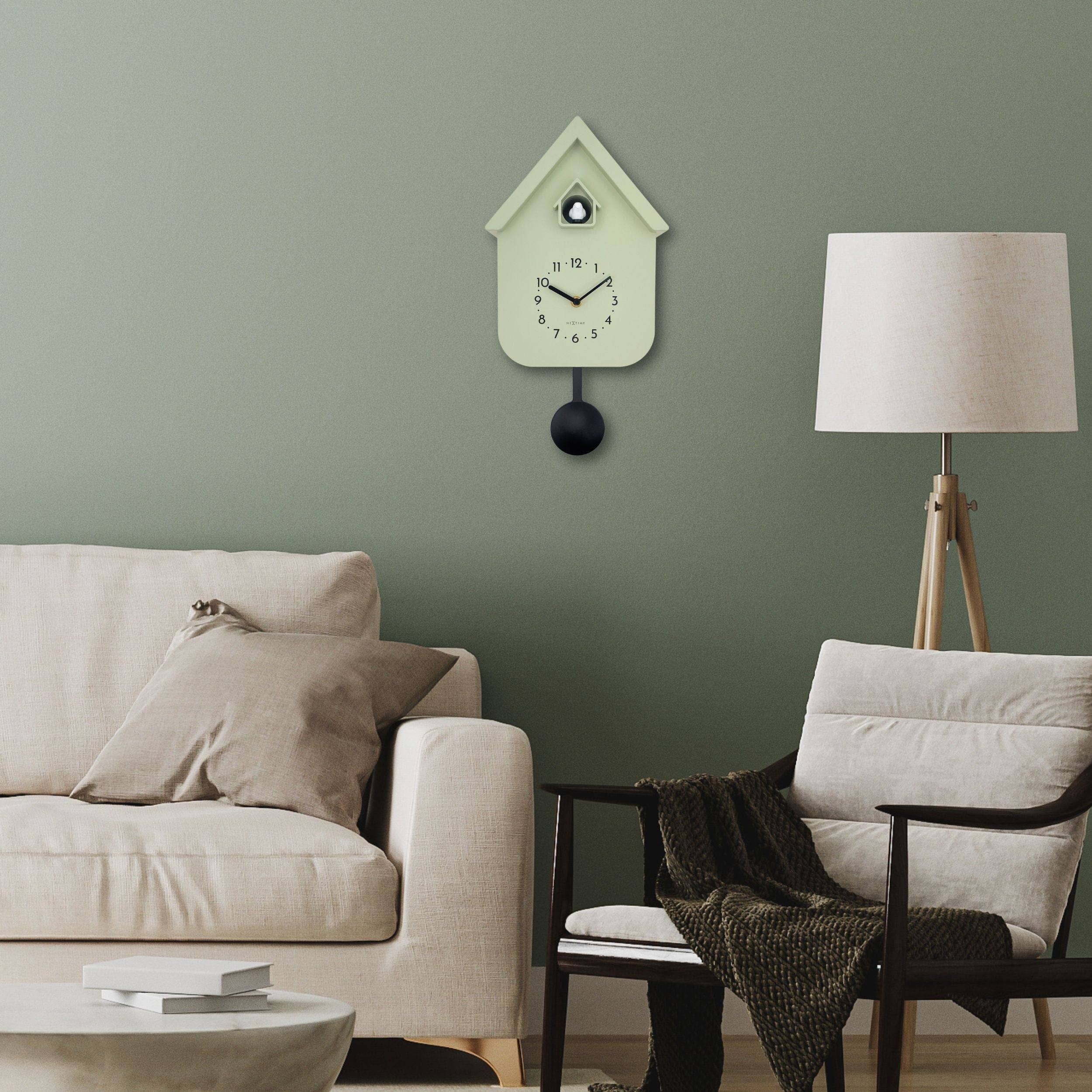 Pale green birdhouse wall clock with black pendulum and minimalist hands, Twitter cuckoo model