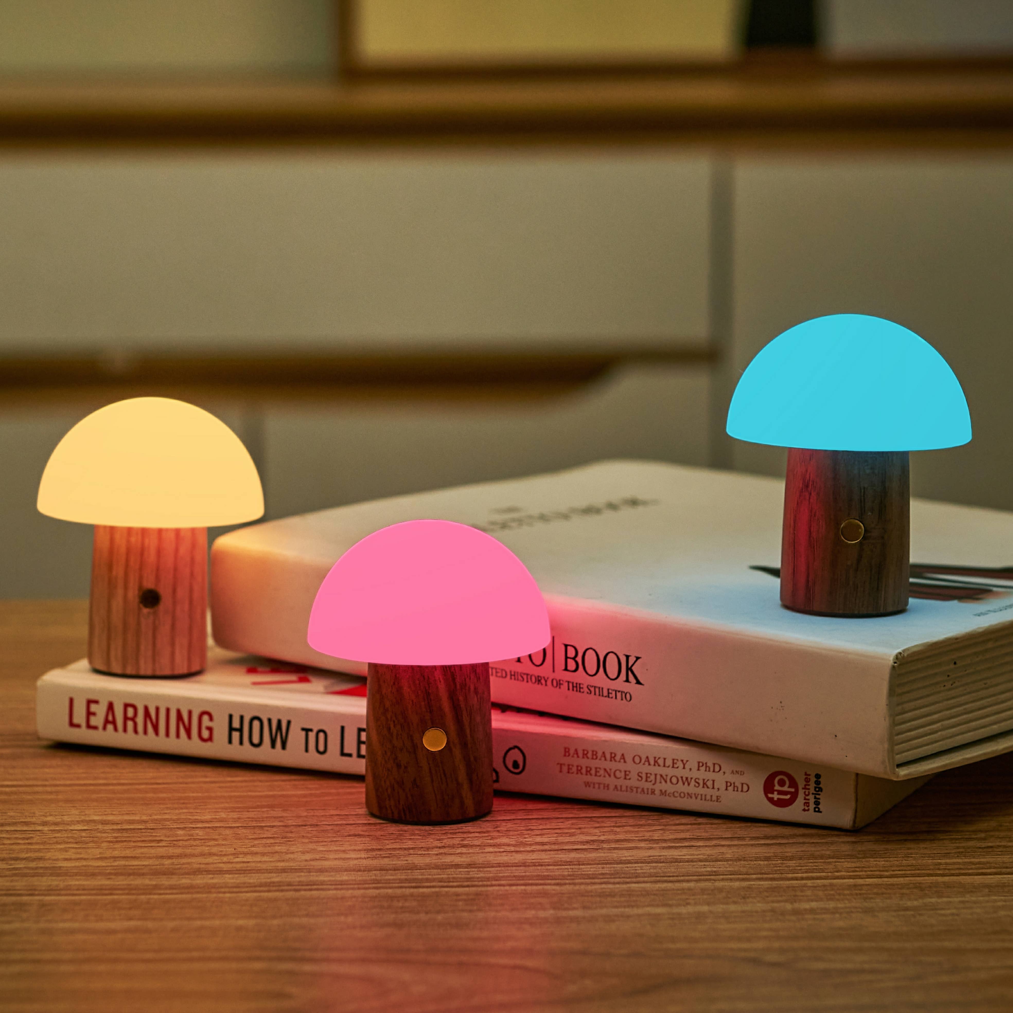 Three Alice Mushroom Lamps in super mini walnut size glowing yellow, pink, blue