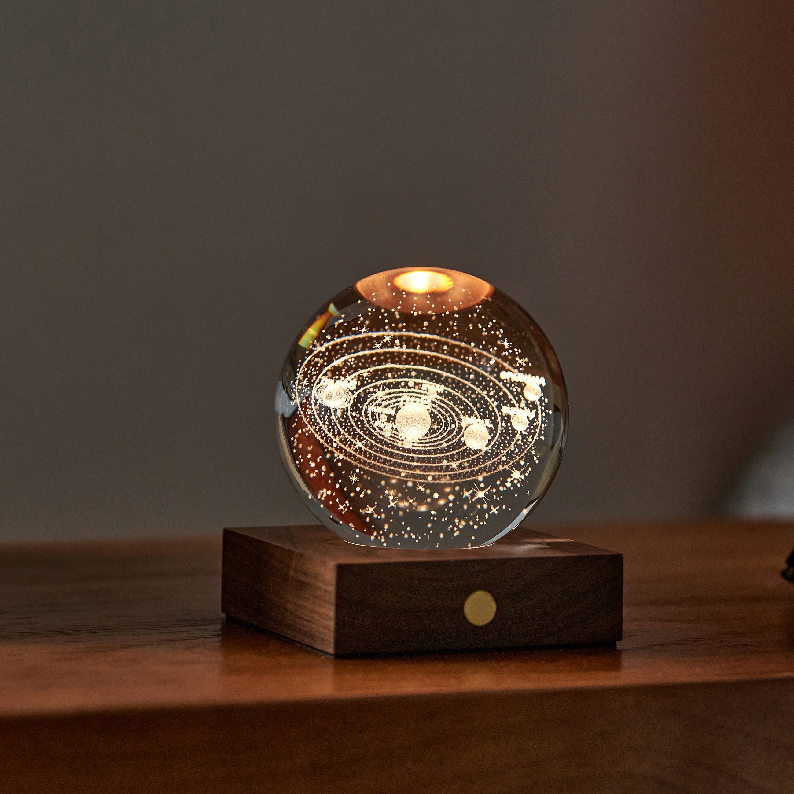 Amber Crystal Light Golf: illuminated solar system glass sphere on wood base