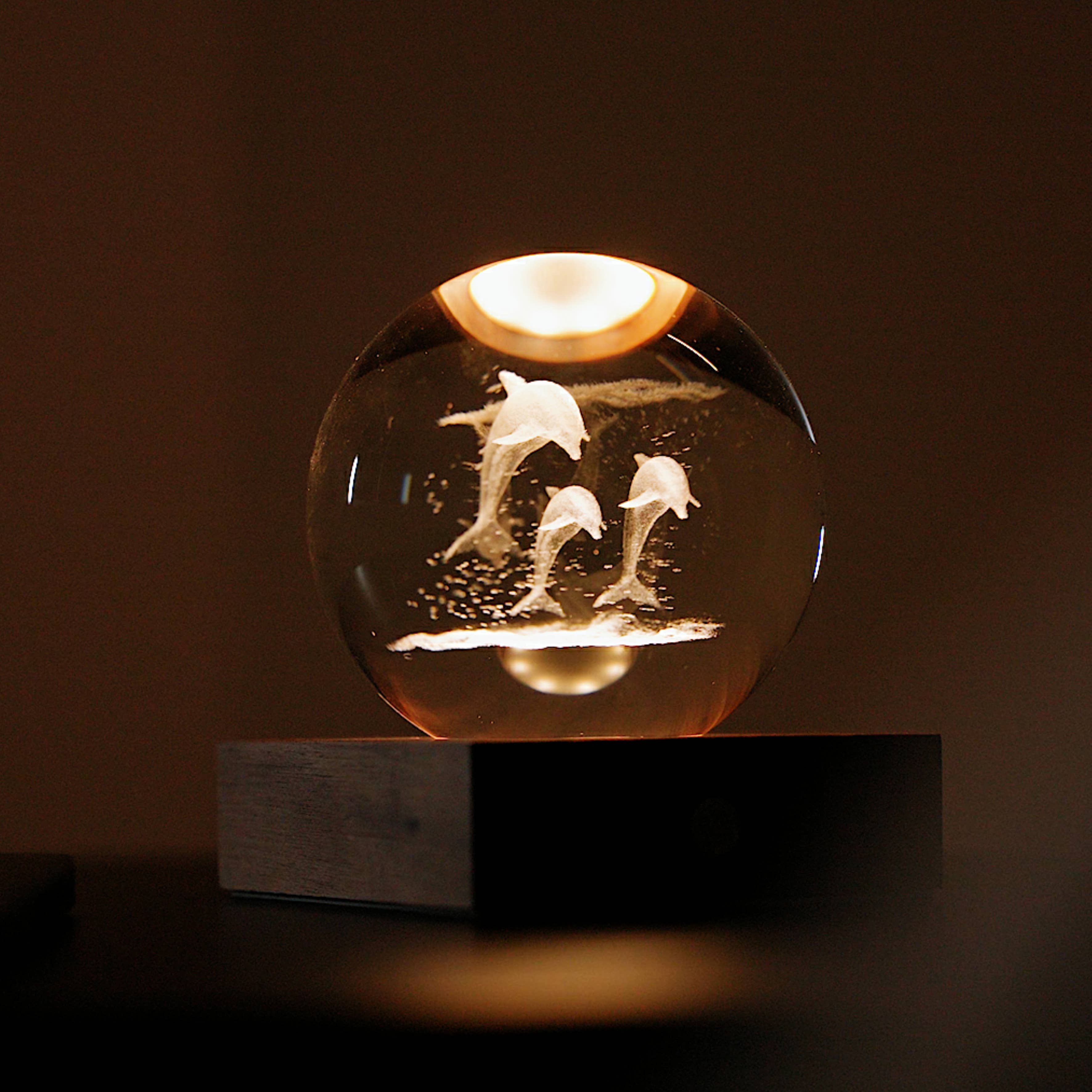 Glowing Amber Crystal Light orb with etched leaping dolphins