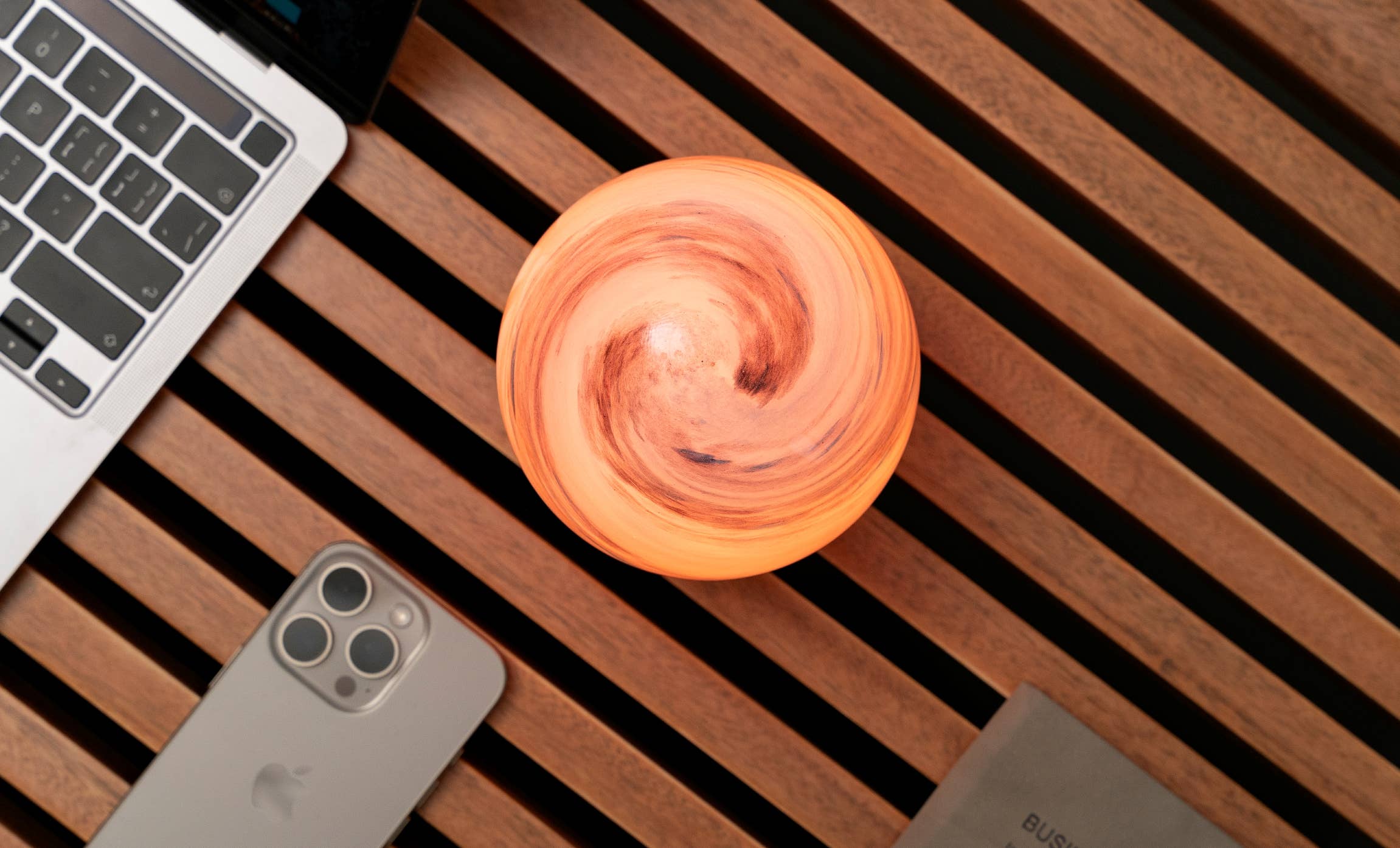 Glowing orange marble-patterned spherical AstraGlass Light Large Sand Storm lamp