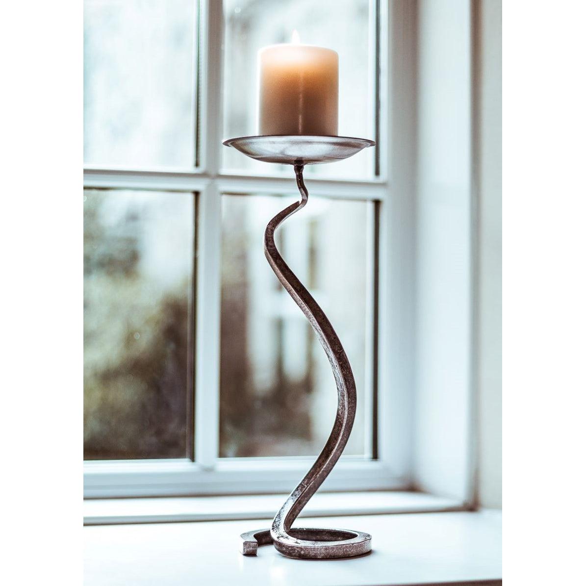 Bent Square rustic wrought iron candle holder with amber pillar candle