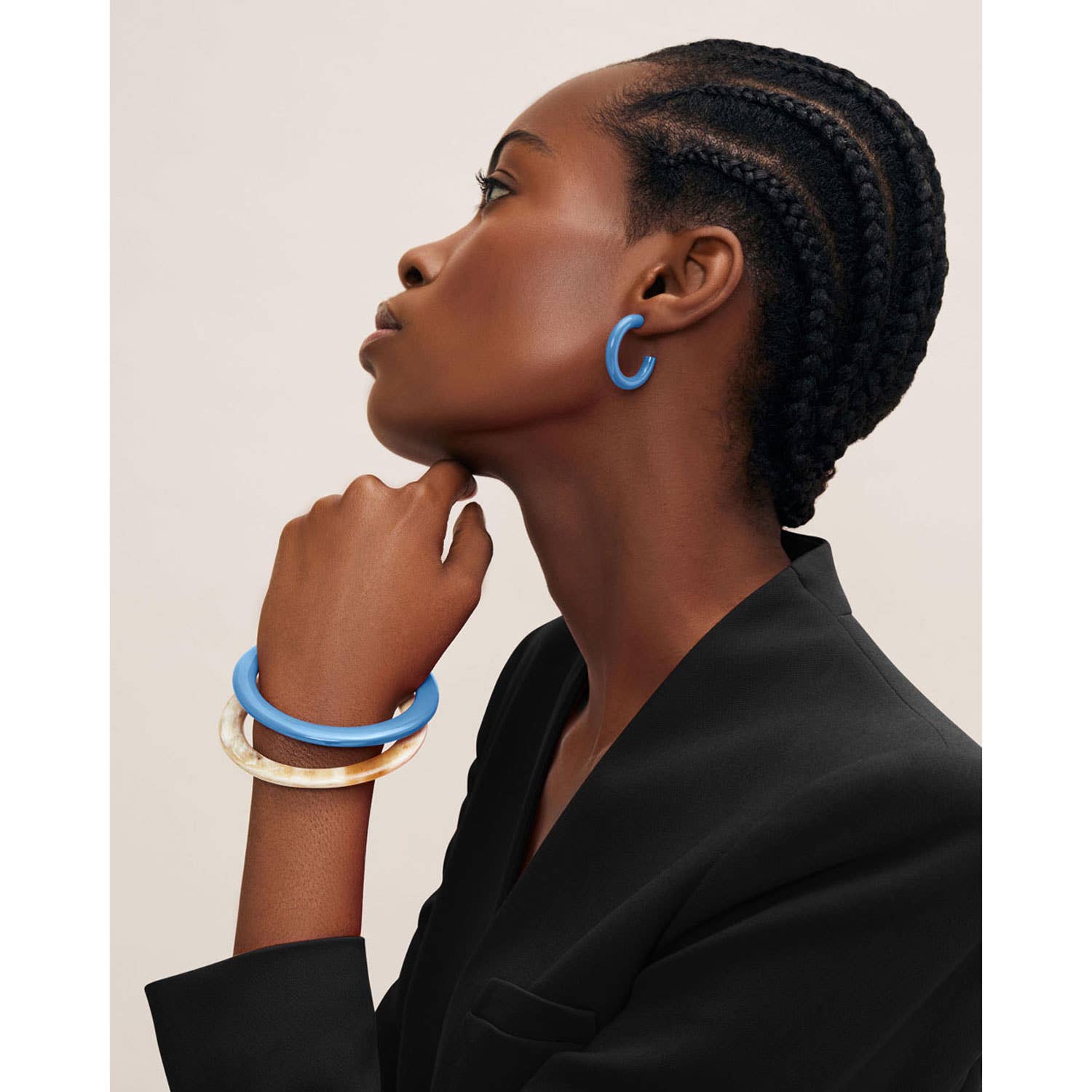 White natural buffalo horn bangle with glossy blue hoop earrings