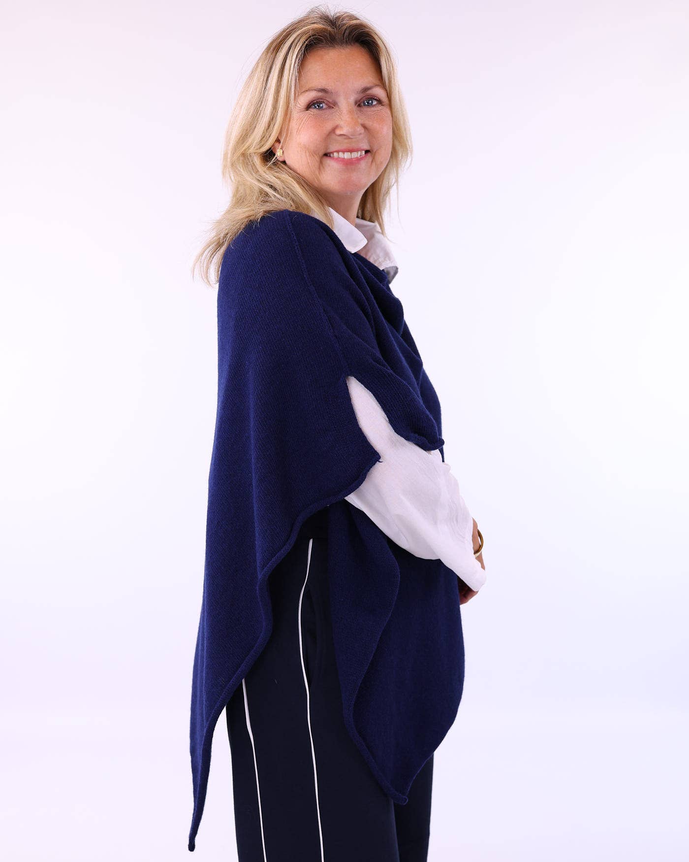 Navy blue cashmere blend poncho draped over shoulders in olive style