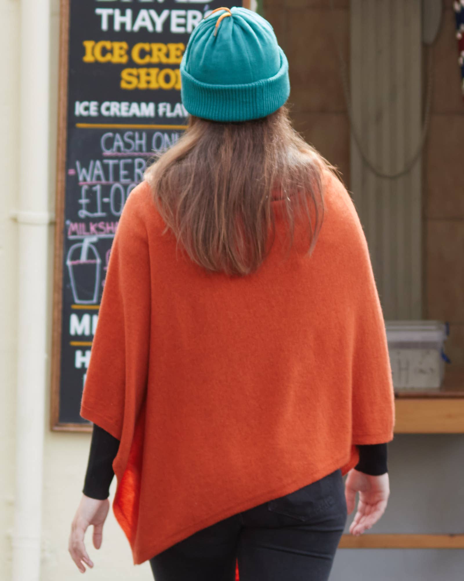 Vibrant orange Classic Cashmere Blend Poncho in Lilac over black leggings