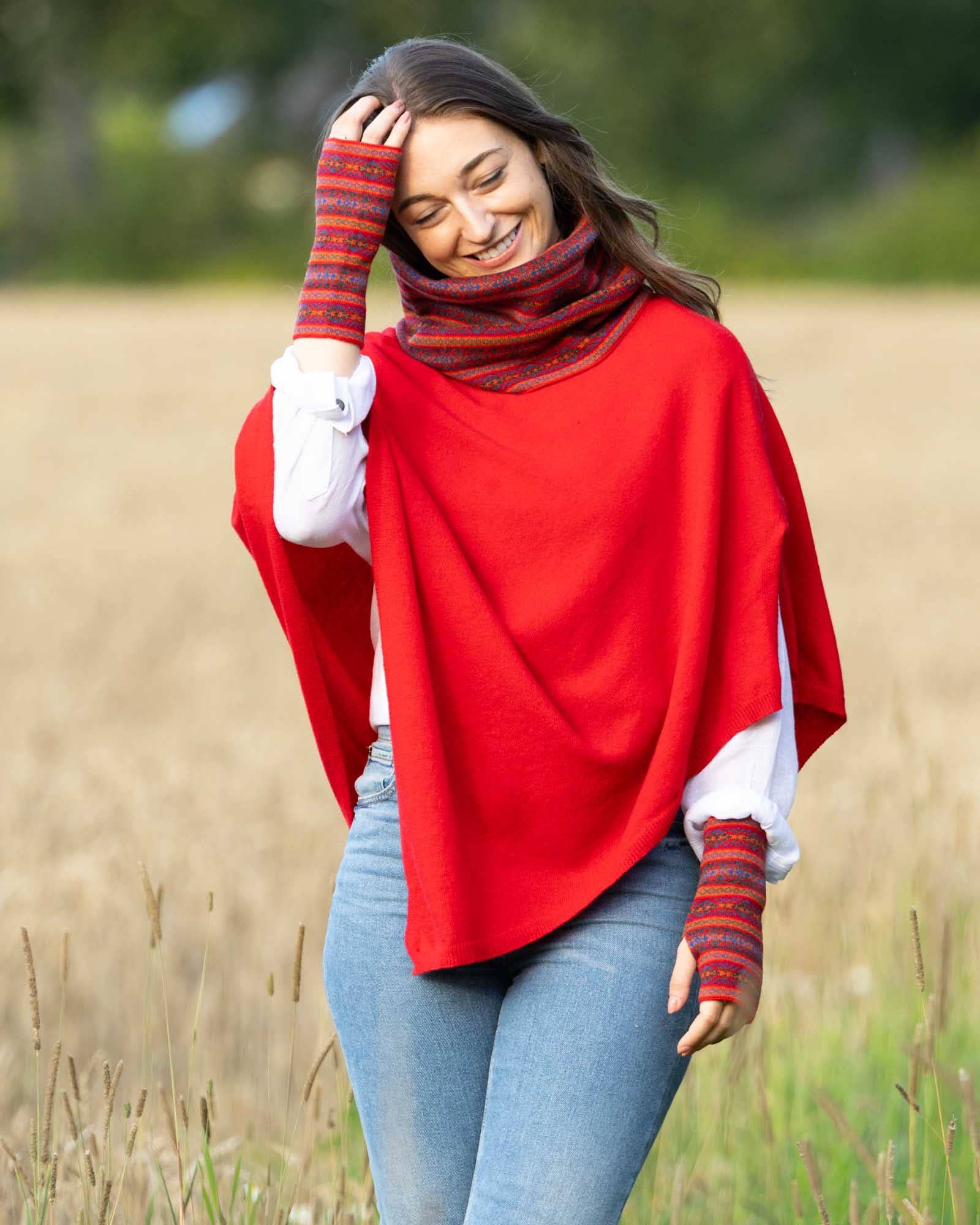 Vibrant red cashmere blend poncho with lilac cozy drape and striped gloves