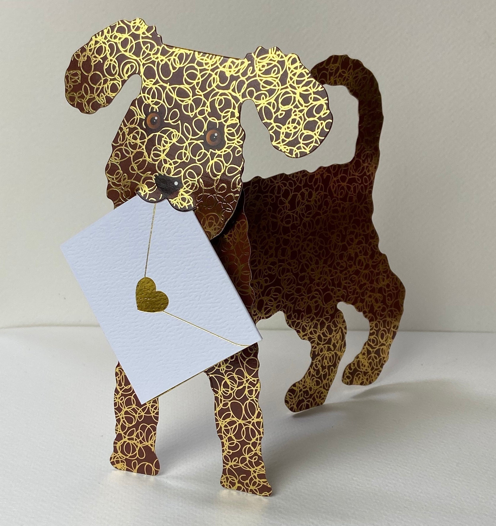 Charming brown and gold paper Coco Dog holding white card with golden heart charm