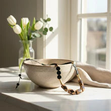 Beige ceramic bowl with subtle texture for cord necklace display