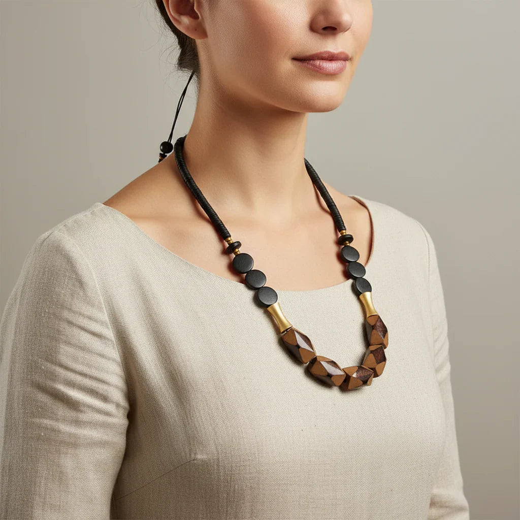 Cord necklace with wood and gold-plated geometric beads
