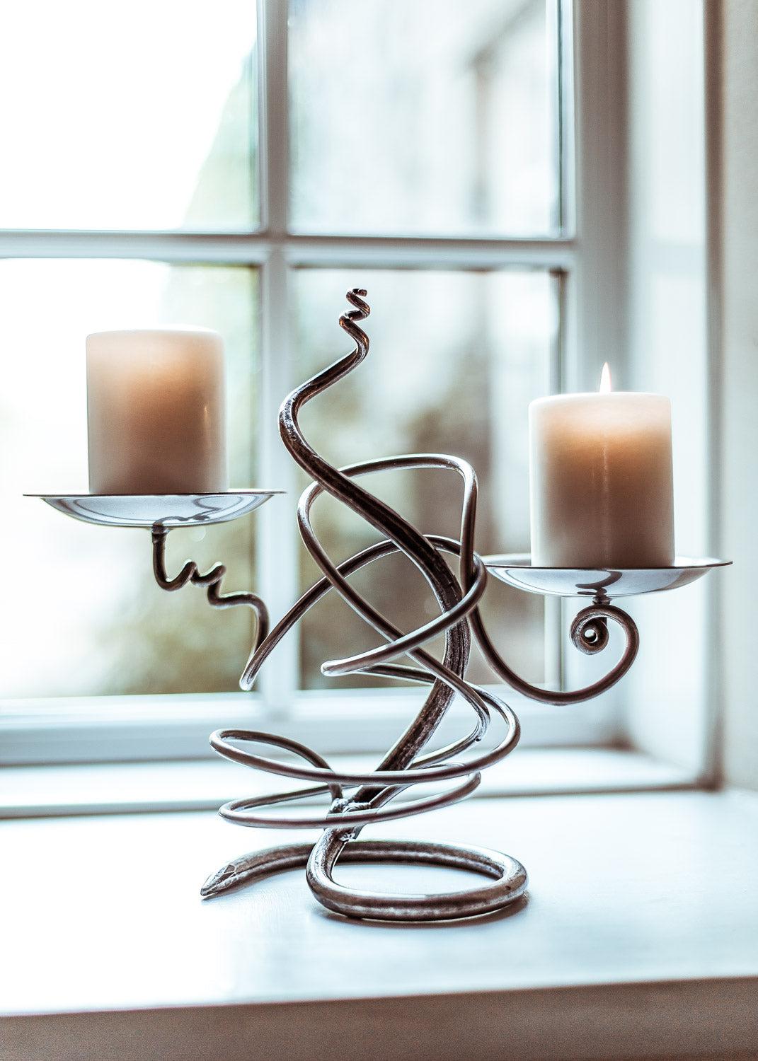 Double Tangle silver wire candle holder with swirling design and two curved arms holding beige candles