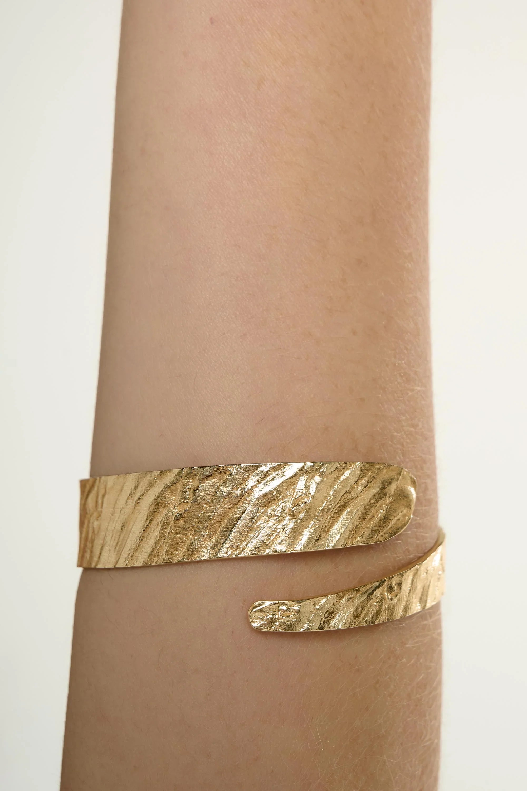 Gold Riva Bangle: textured gold-toned metal cuff bracelet