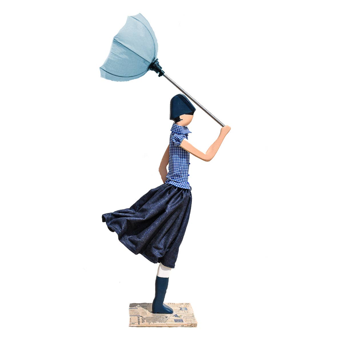 Laoura Lamp: Stylized woman figurine in checkered shirt, navy skirt, hat, holding blue umbrella