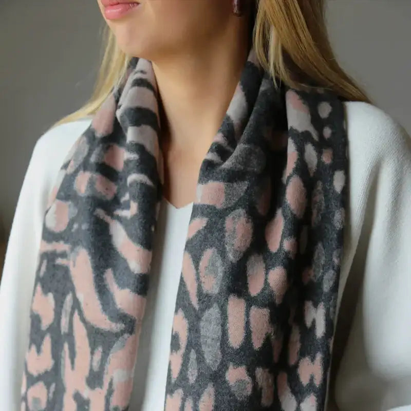 Pink and gray animal print scarf with a soft, plush texture.