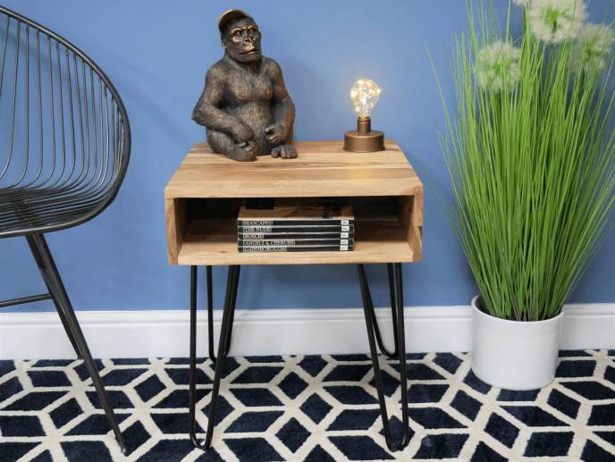 Rustic wooden side table with black hairpin legs, open shelf and bronze gorilla statue
