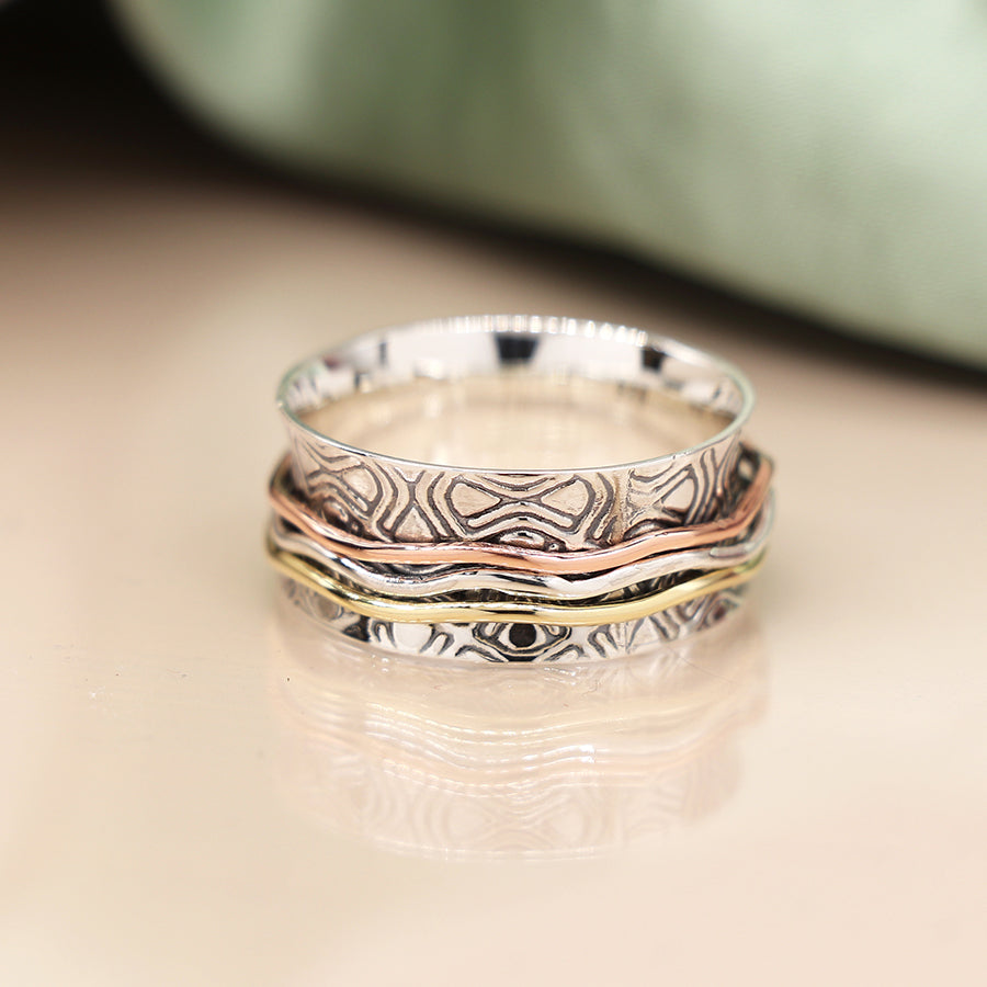 Silver embossed spinning ring with brass, copper, silver bands