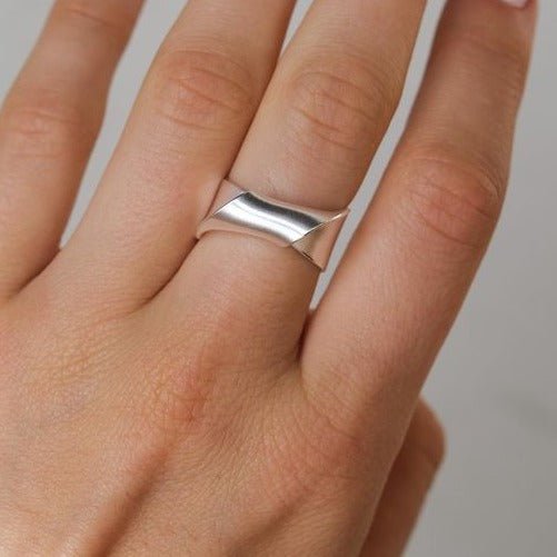 Sleek silver ring with modern geometric intersecting bands